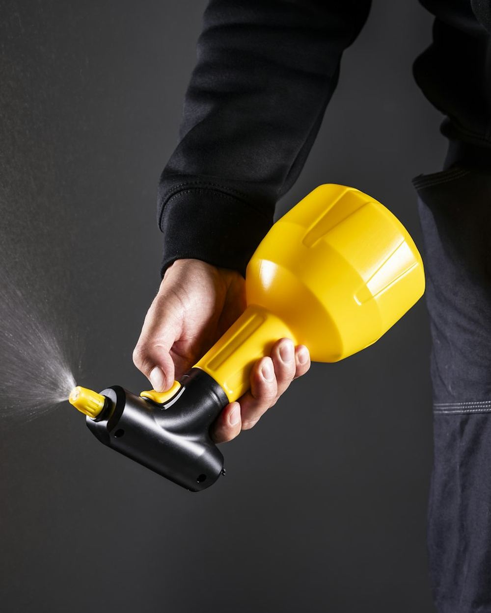 A technician using a pesticide sprayer