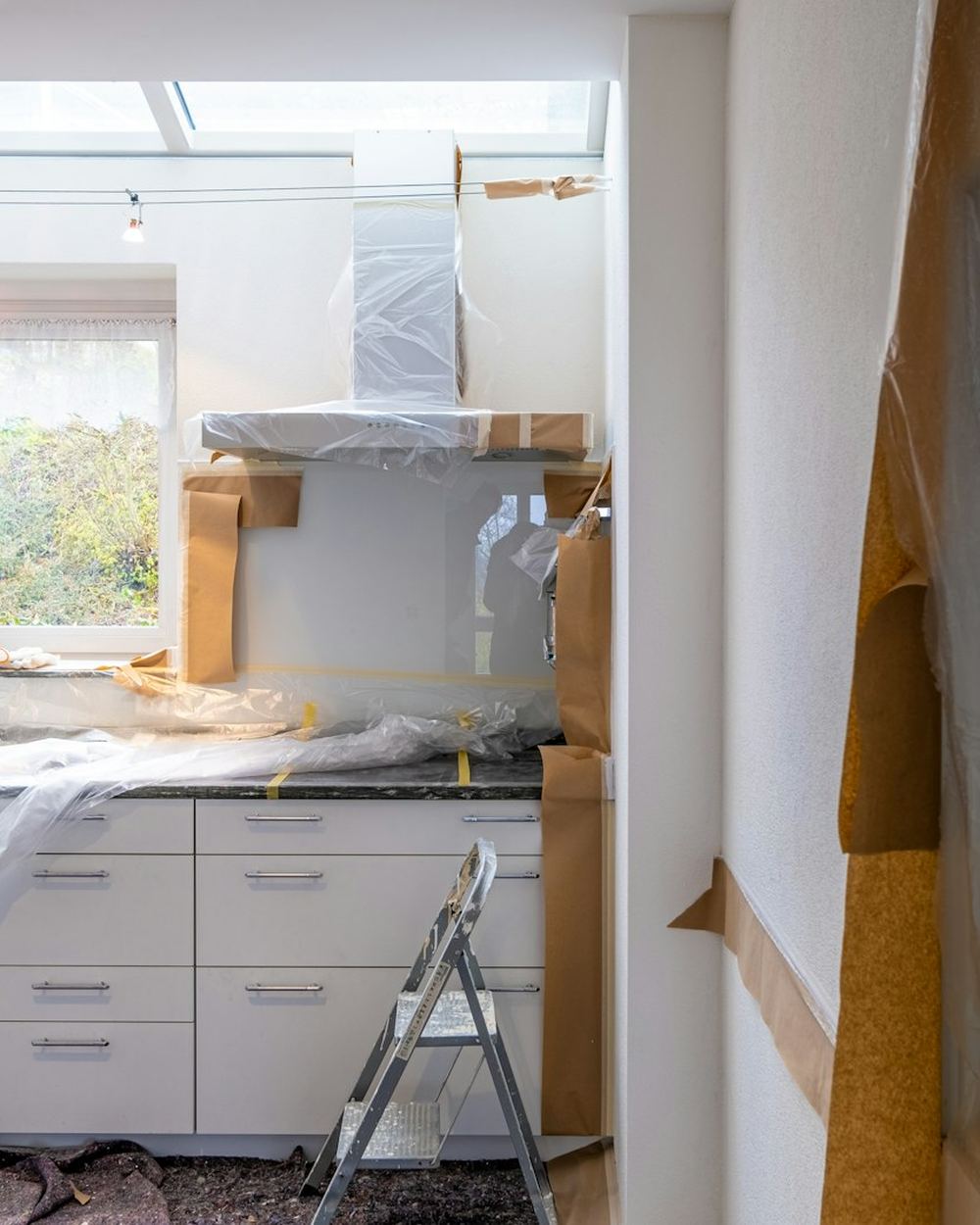A kitchen mid-renovation with cabinets covered