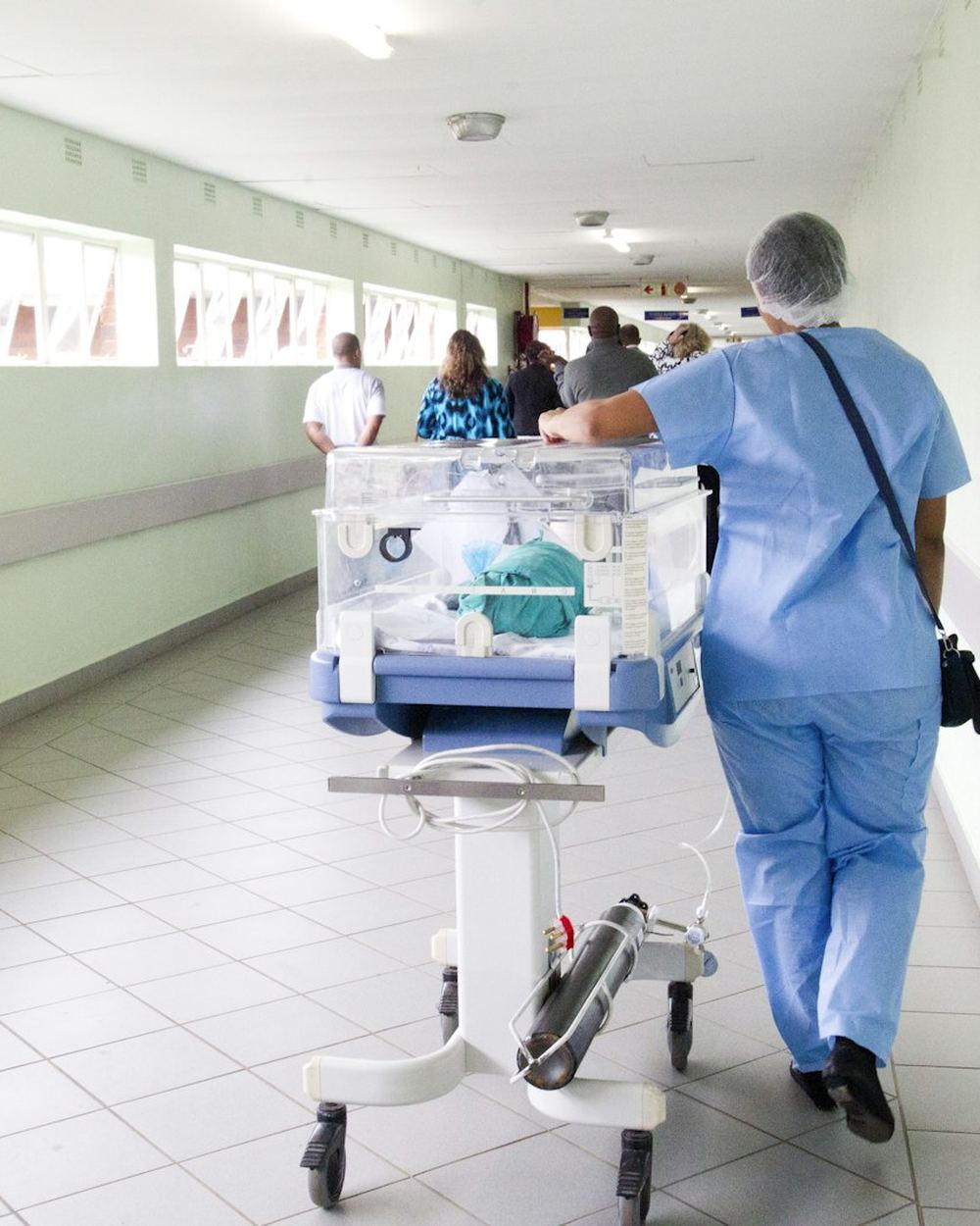 A clinic corridor with staff in scrubs
