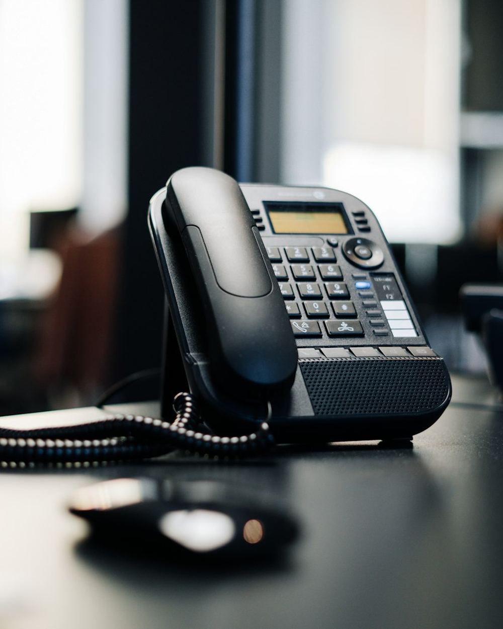 A desk phone in a busy office
